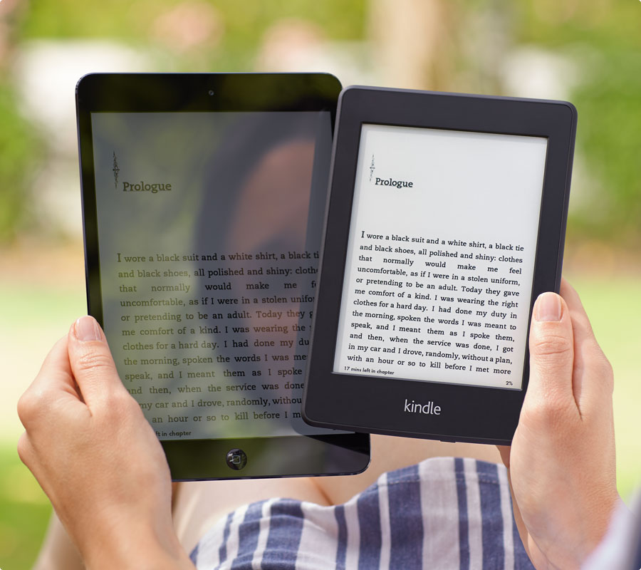 Ereader and iPad held together to show the difference in screen glare under bright conditions.