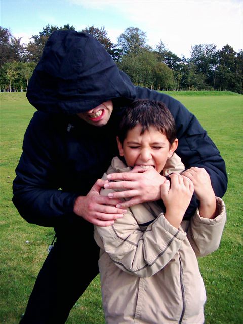 A boy bites the hand of his kidnapper.